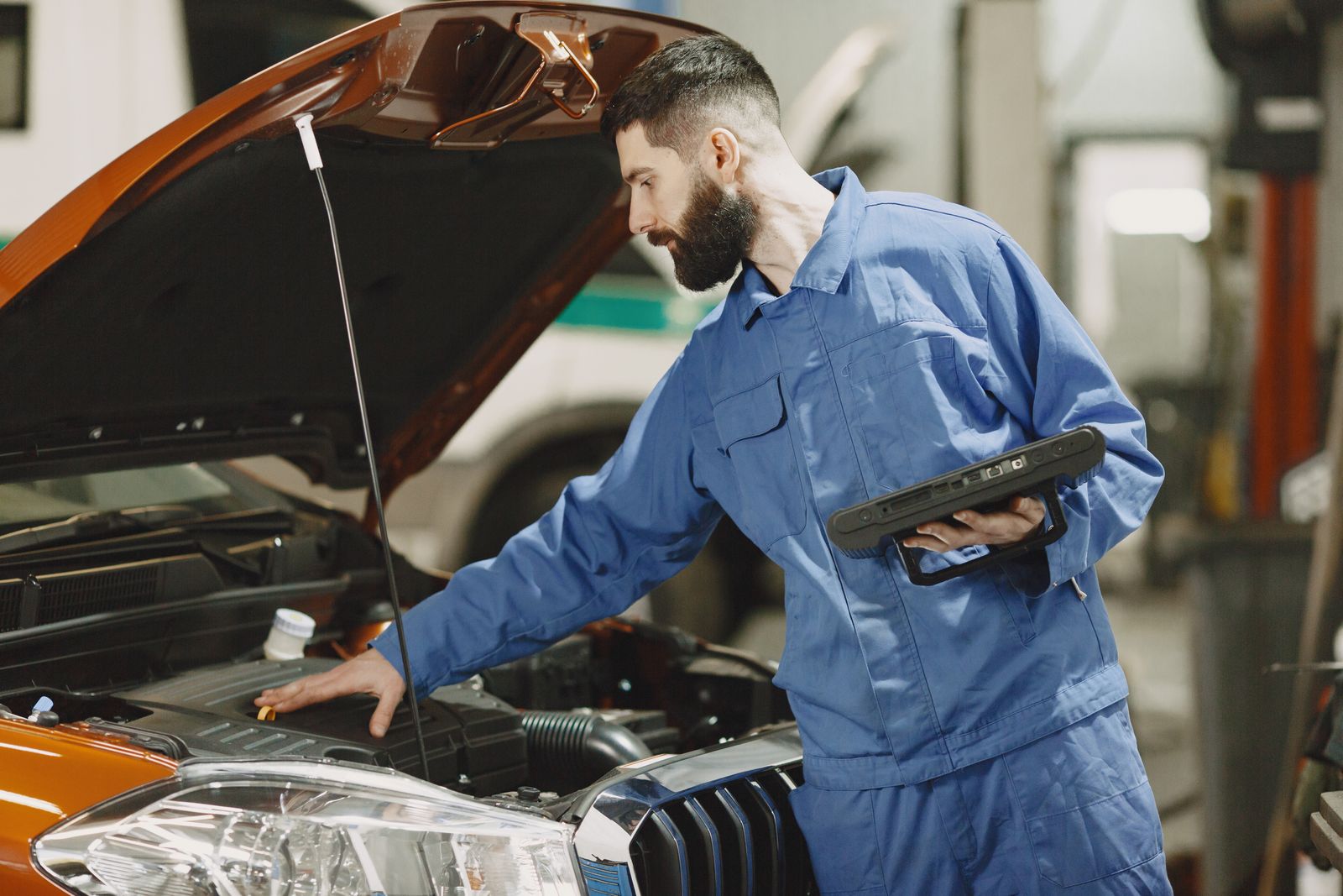Technician inspecting an engine bay